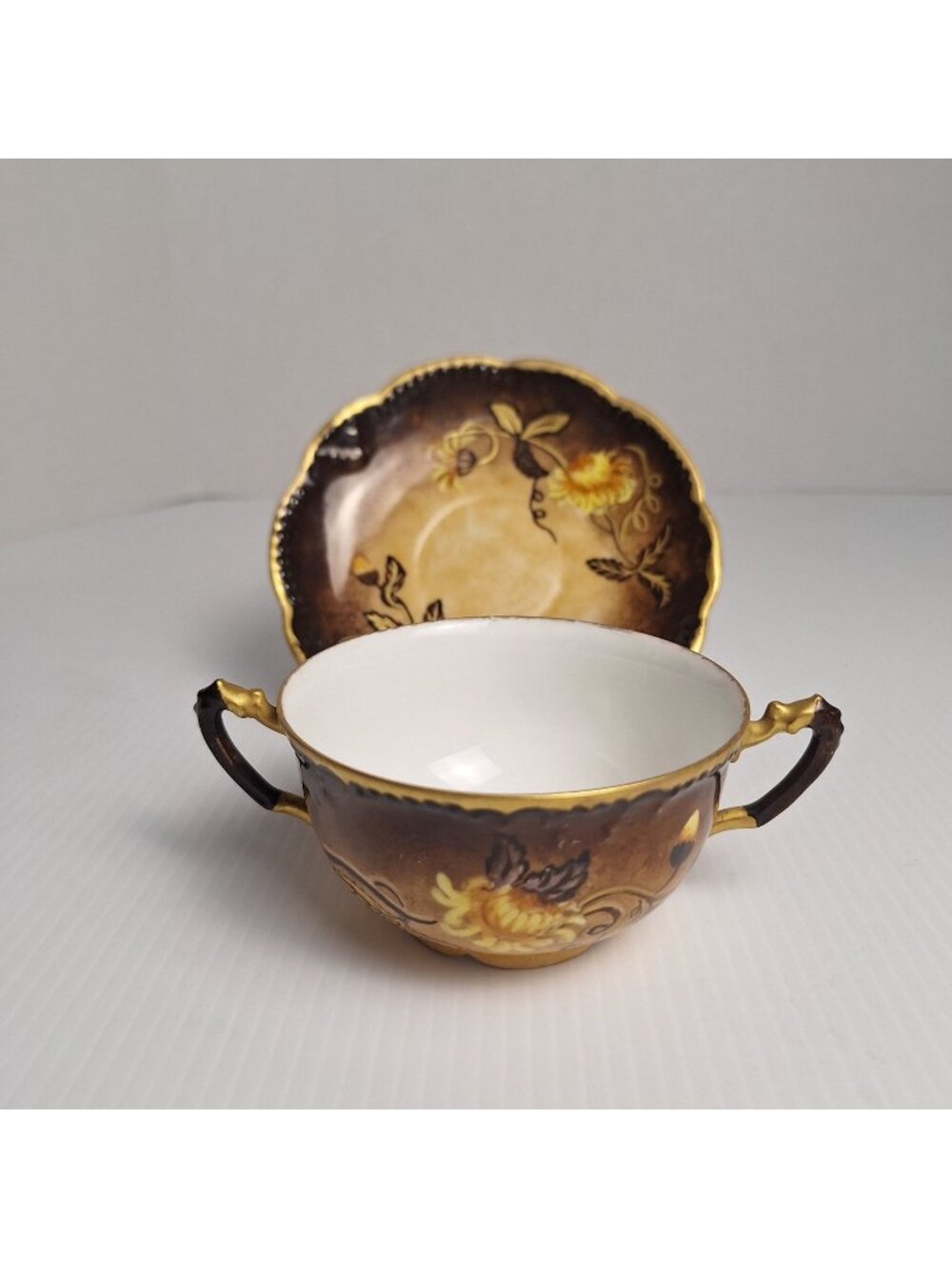 ANTIQUE HAND-PAINTED PORCELAIN DOUBLE HANDLE TEACUP & SAUCER AK FRANCE SIGNED